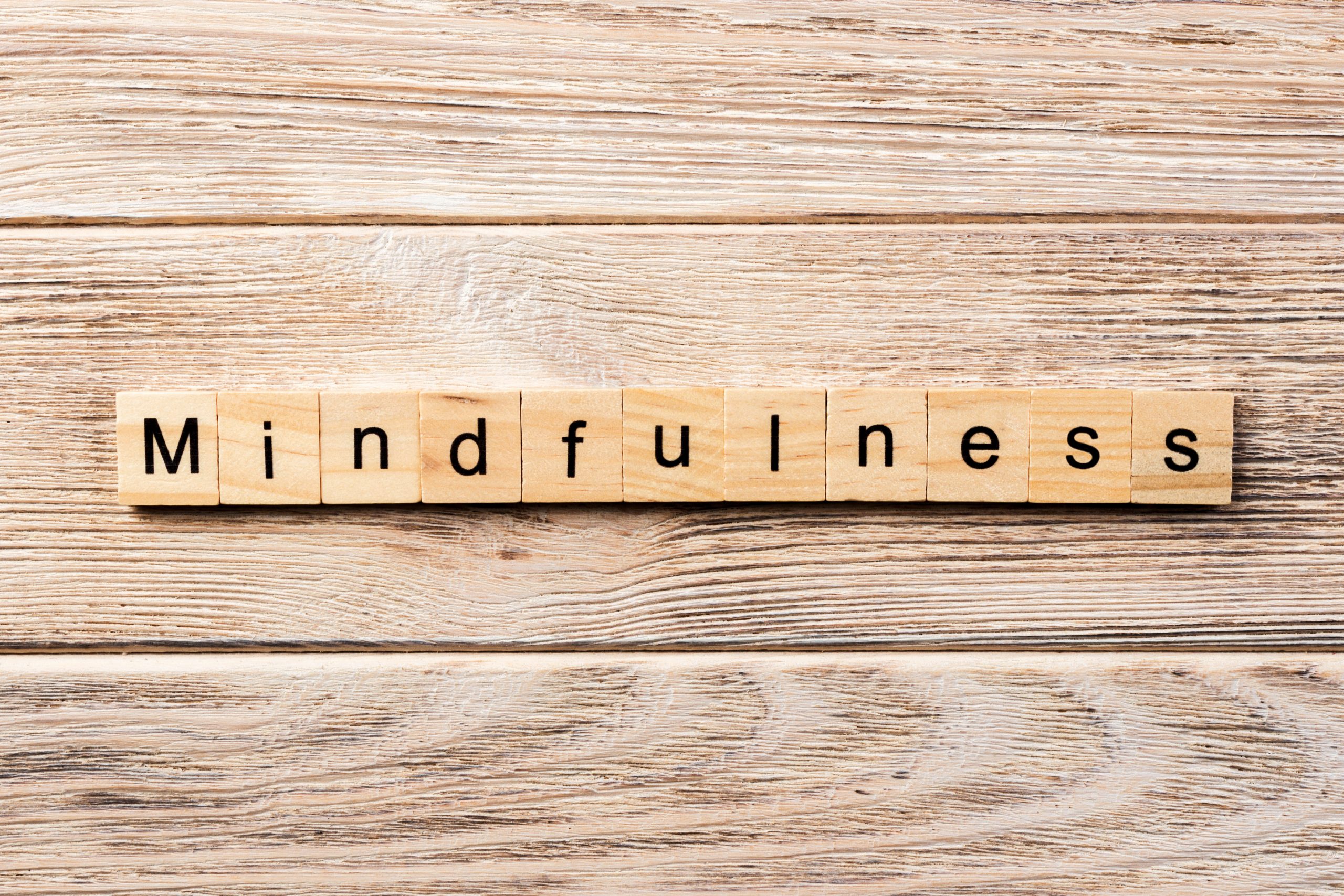 mindfulness word written on wood block. mindfulness text on table, concept Mindfulness Meditation